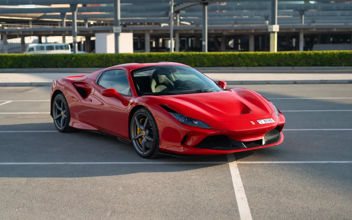 Red Ferrari F8 Tributo Spyder convertible driving in Dubai during Christmas